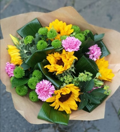 Sunflower Helianthus bouquet with rolled leaves and green chrysanthemum 