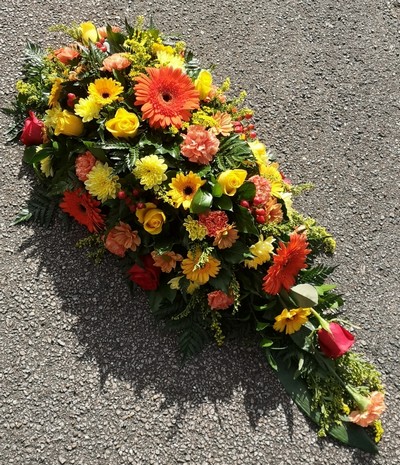 funeral flowers, spray, oasis, orange, yellow, red  colourful, harold wood florist, delivery, romford 