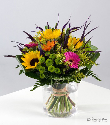 Pink yellow orange green flowers in a glass vase