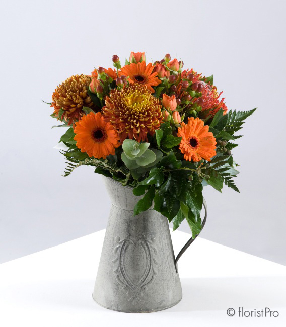 Orange blooms in a rustic jug container